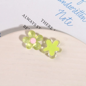 Macro view of resin flower accessories with glitter details for DIY hair clips