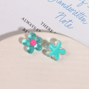 Macro shot of glitter resin five-petal flower charms for DIY hair clip accessories