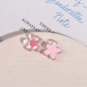 Macro shot of glittery pink resin flower charms for DIY jewelry and hair accessories