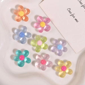 Macro shot of colorful resin flower charms with glitter finish for DIY hair accessories