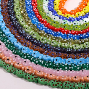 Close-up of colorful handmade polka dot fish ceramic beads for DIY jewelry making