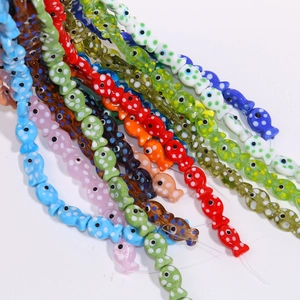 Detailed view of colorful handmade ceramic fish beads with polka dots for DIY jewelry