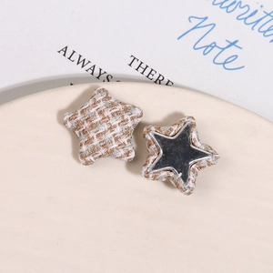 Detail of tweed star-shaped fabric buttons with metallic mirror inserts for DIY crafts