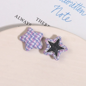 Detail of star-shaped fabric buttons and silver mirror inserts for DIY headwear accessories