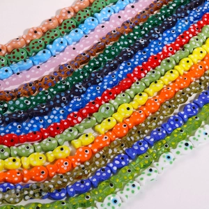 Macro shot of colorful fish-shaped ceramic beads with polka dots for DIY jewelry making