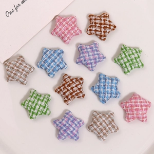 Macro view of star-shaped fabric patches in colorful houndstooth tweed for DIY crafts