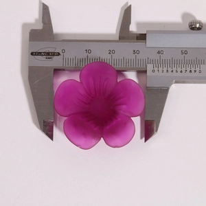 Macro shot showing a 35.5mm diameter measurement of the matte resin flower charm