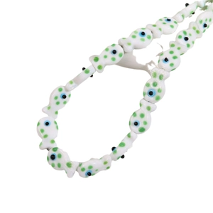 Handmade ceramic fish beads with green polka dots and blue evil eye charms for DIY jewelry