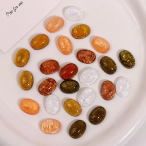 Macro shot of oval resin cabochons with sand-like texture for DIY jewelry making