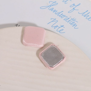 Macro shot of pink satin square buttons with flat metal back for DIY crafts
