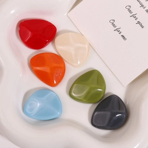 Close-up of colorful irregular resin charms with geometric texture for DIY jewelry making