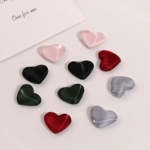 Detail of multi-colored heart-shaped satin fabric buttons for DIY jewelry making