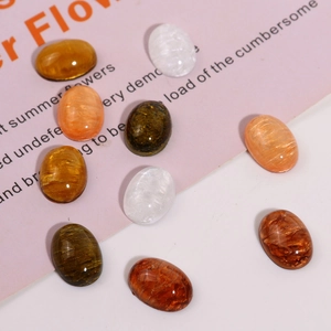 Detailed view of glossy oval resin cabochons with quicksand texture for DIY jewelry making