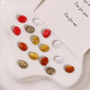 Macro detail of glitter resin oval cabochons in various colors for DIY jewelry making