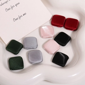 Square fabric buttons in assorted silk colors including green pink and burgundy