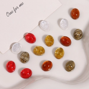 Close-up of colorful oval resin glitter cabochons for DIY jewelry making and crafts