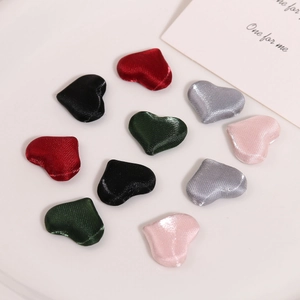 Detail of heart-shaped satin fabric buttons in multiple colors for DIY jewelry crafts