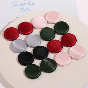Boutons ronds en tissu de soie pour loisirs créatifs, coloris variés sur plateau céramique