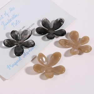 Detail of floral resin hair clips featuring ink wash and amber marble texture