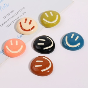 Detailed view of colorful resin smiley face charms for DIY accessories and crafts