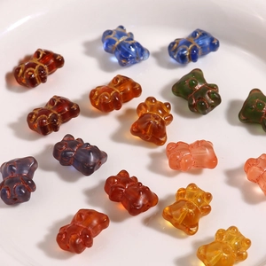 Macro shot of colorful glass bear beads with gold textured accents for DIY jewelry making