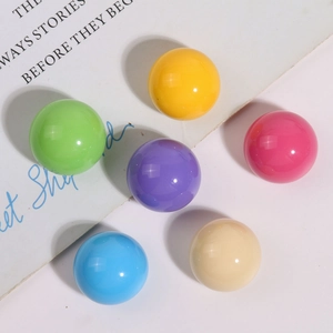 Close-up of polished Morandi resin ball beads in assorted pastel colors for DIY jewelry