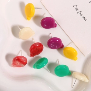 Macro shot of colorful resin stud earrings set with marble texture and metal needles