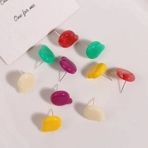 Close-up of assorted colorful resin ear studs in smooth rounded shapes for jewelry making