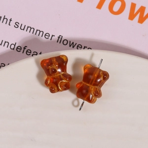 Detailed view of amber brown teddy bear glass beads with gold outline for DIY jewelry