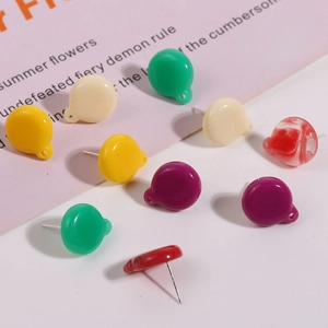 Detailed close-up of colorful resin balloon earrings with shiny surface and silver pins