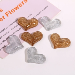 Macro detail of heart-shaped glitter resin charms for DIY hair accessories and crafts