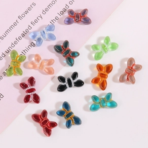 Detailed view of colorful translucent glass butterfly beads for DIY jewelry making and crafts
