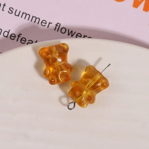Close-up of amber translucent bear-shaped resin beads for DIY jewelry making