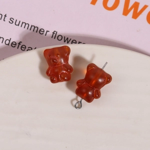 Detailed view of amber brown glass bear charms for DIY jewelry making and earrings