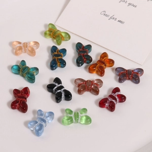 Detailed view of colorful glass butterfly beads for DIY jewelry making and handmade crafts