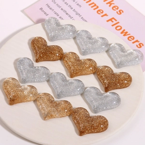 Sparkly gold and silver glitter resin heart charms for DIY crafts and hair accessories