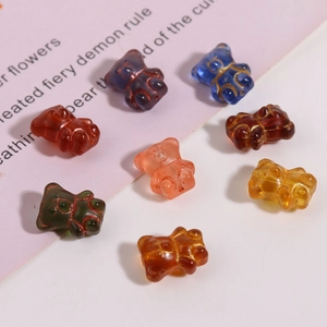 Detail of colorful teddy bear glass beads with gold accents for DIY jewelry making