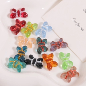 Macro shot of colorful glass butterfly beads with hand-wrapped wire for DIY jewelry