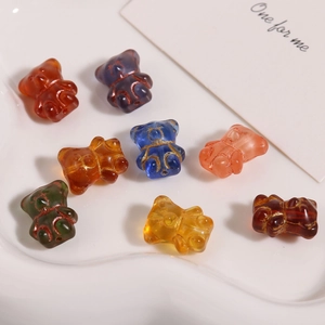 Detailed view of colorful translucent bear glass beads for DIY jewelry making and crafts