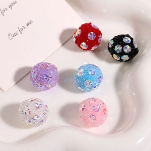 Colorful frosted beads with sparkling star crystals in a white ceramic dish for DIY jewelry