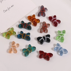 Macro detail of colorful transparent glass butterfly beads for DIY jewelry making