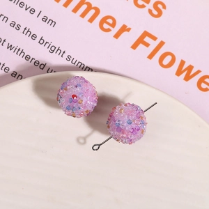Macro detail of pink glitter sugar ball resin beads for DIY jewelry making