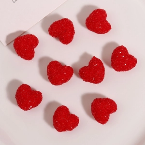 Macro shot of 9 red resin heart charms with sparkling sugar-like texture for DIY jewelry