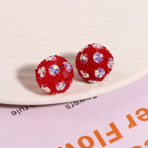 Macro shot of red Shamballa earrings featuring sparkling star-shaped crystal embellishments