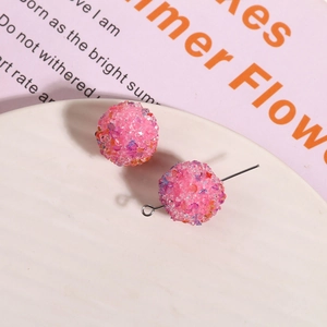 Macro detail of pink glitter crystal ball resin beads for DIY jewelry and earring making