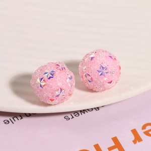 Detailed macro view of pink Shamballa sugar beads with sparkling star-shaped sequins