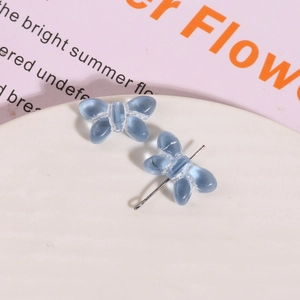 Detailed view of translucent blue glass butterfly charms for DIY jewelry crafting