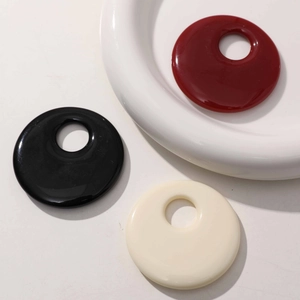 Set of three 50mm geometric hollow resin ring pendants in red, black, and creamy white