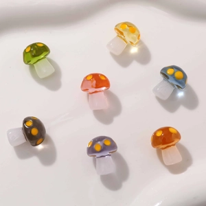 Detailed view of colorful translucent resin mushroom charms for DIY jewelry making