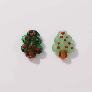Detailed view of handmade green glass Christmas tree beads for DIY jewelry making